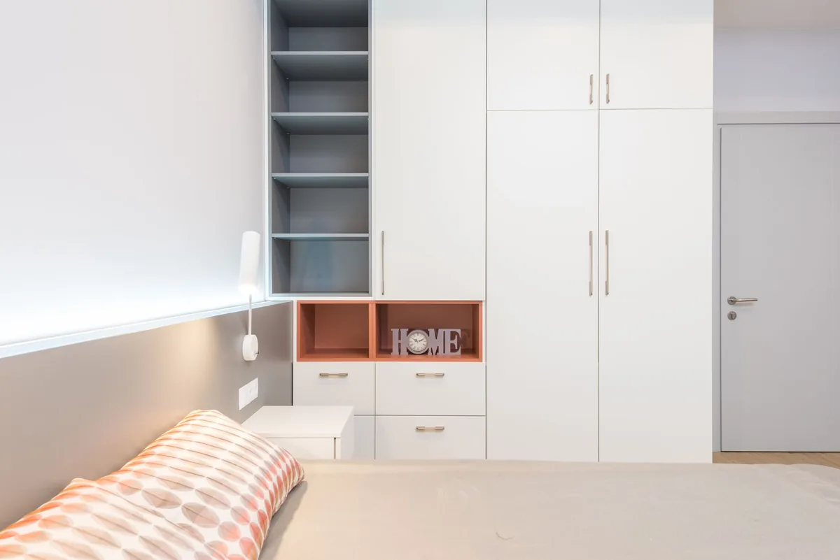 Floor-to-ceiling wardrobe column replacing wide floor dresser in small bedroom