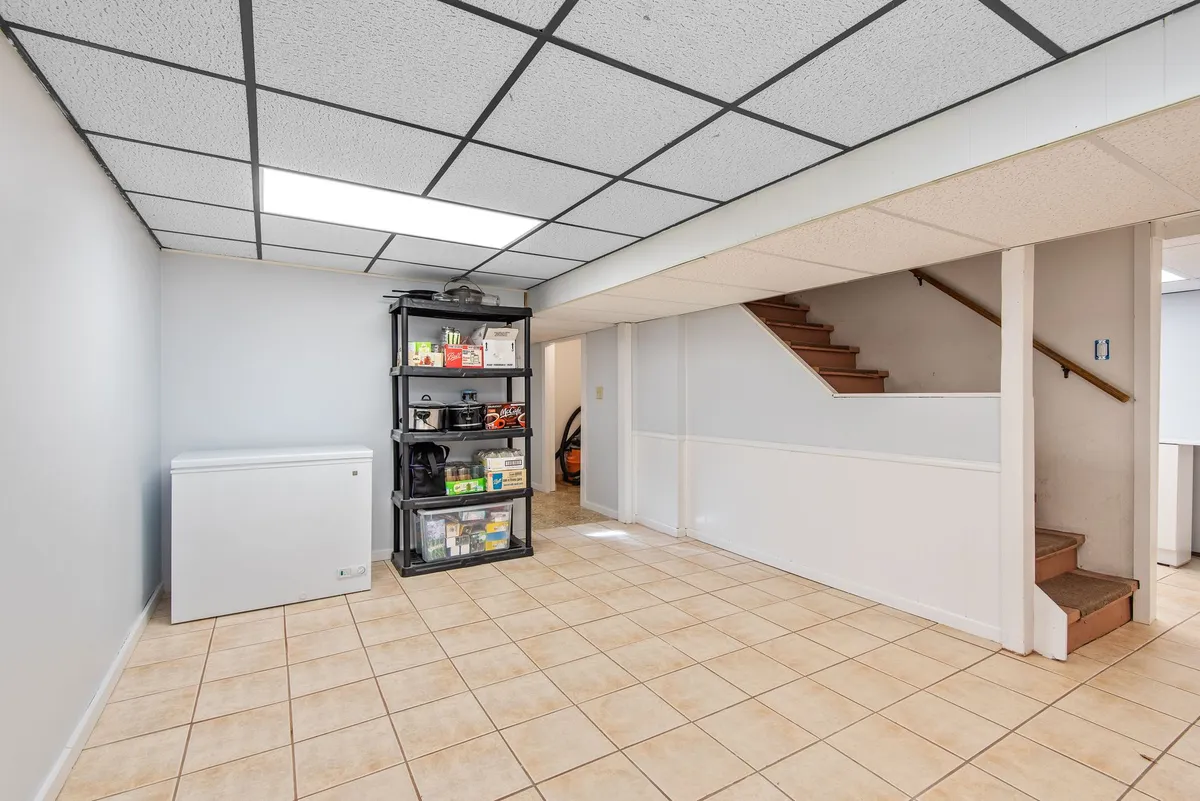 Basement renovation in progress showing framing, insulation, and electrical rough-in before drywall stage