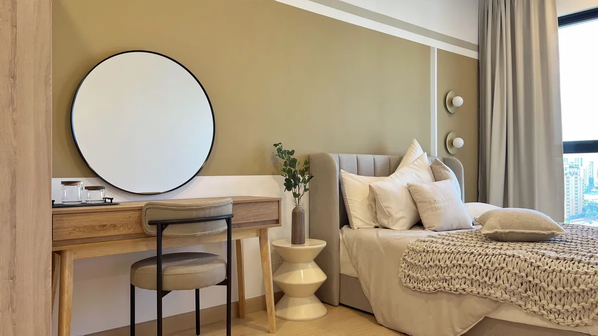 Modern bedroom with layered lighting, upholstered headboard, and warm neutral palette