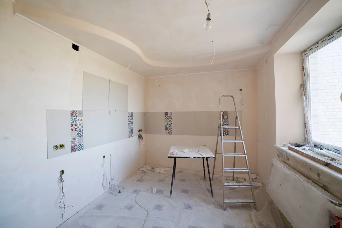 Homeowner reviewing AI-generated room design options on laptop for renovation planning