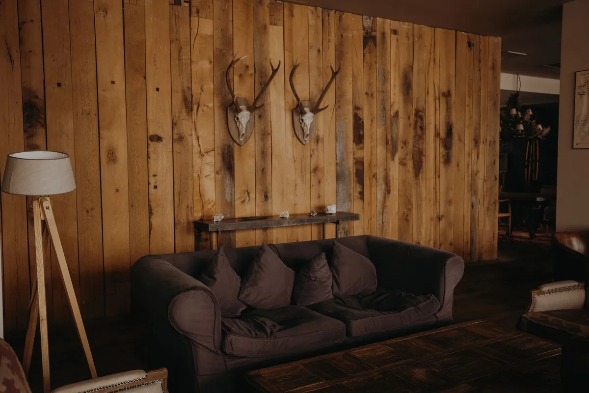 Modern farmhouse living room with shiplap wall and reclaimed wood beam details