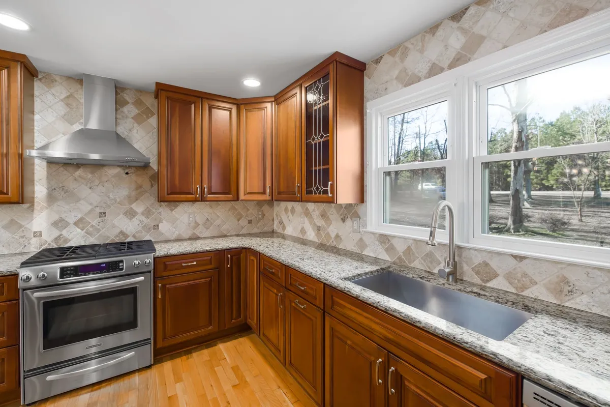 Kitchen renovation showing high-quality cabinetry and stone countertops