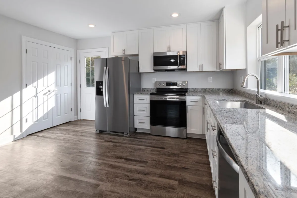 Side-by-side AI render comparing a farmhouse and a sleek contemporary version of the same kitchen layout