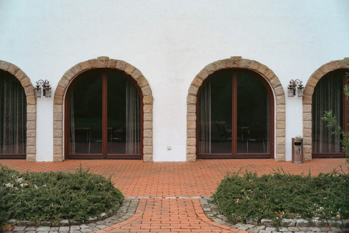 Mediterranean interior featuring terracotta tiles, warm plastered walls, and arched architectural details