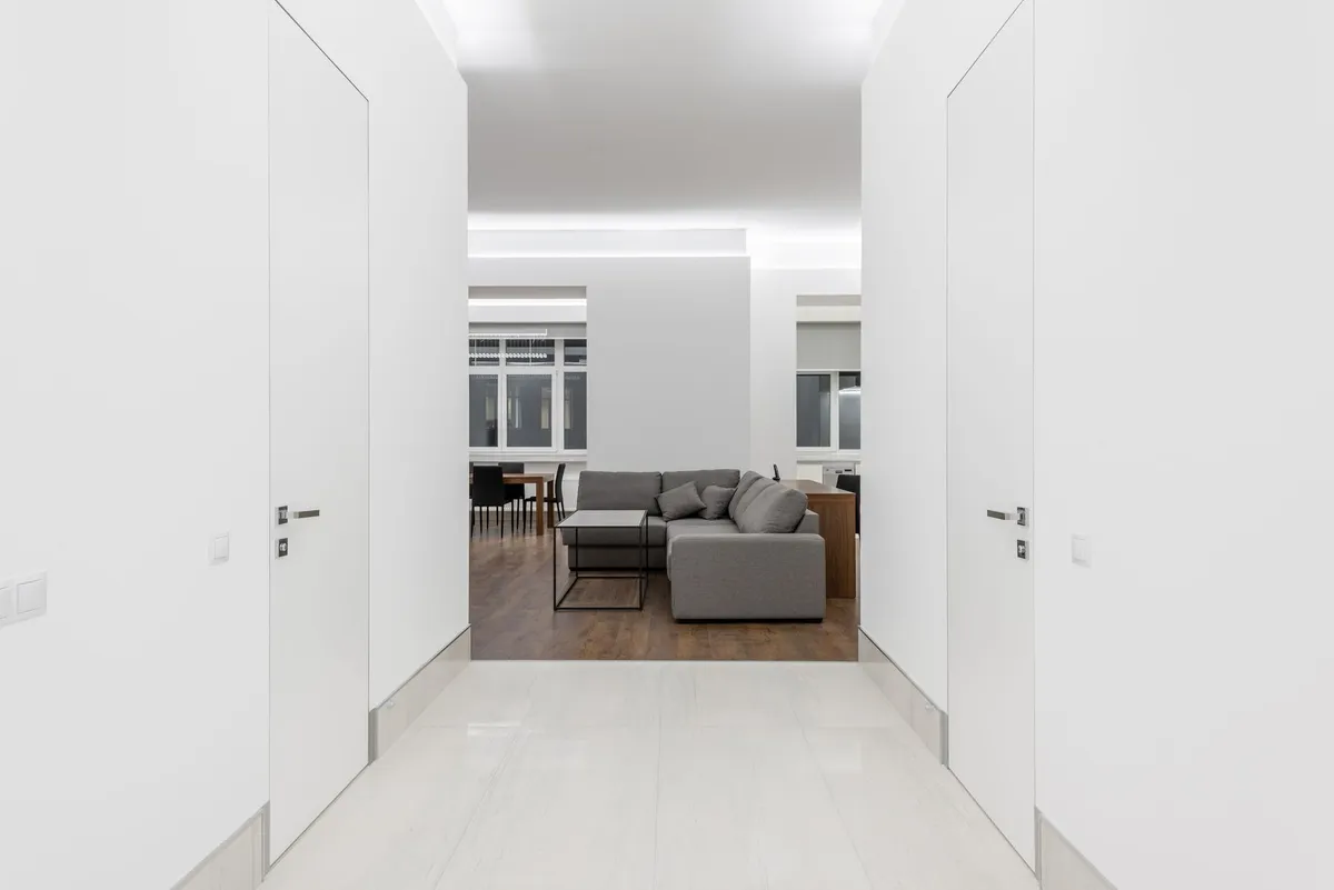 Minimalist bedroom with floating bed frame, neutral textiles, and uncluttered surfaces