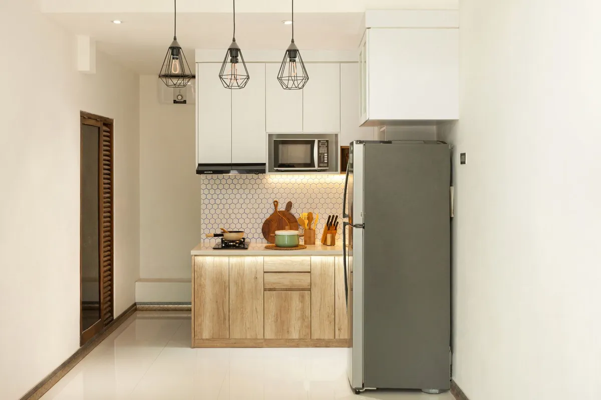 Small studio apartment with monochromatic light walls and trim, ceiling painted one shade lighter to add height